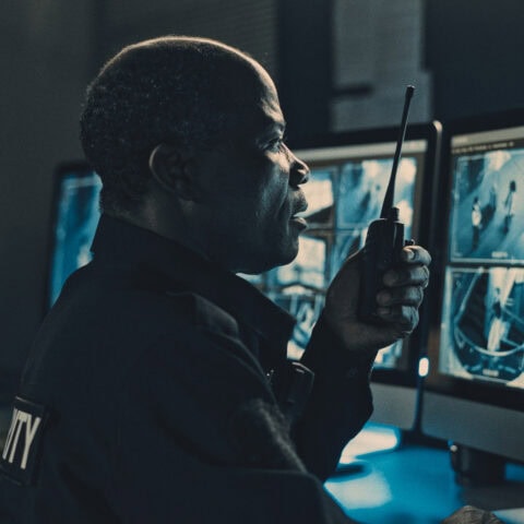 Security officer monitoring cameras with AI